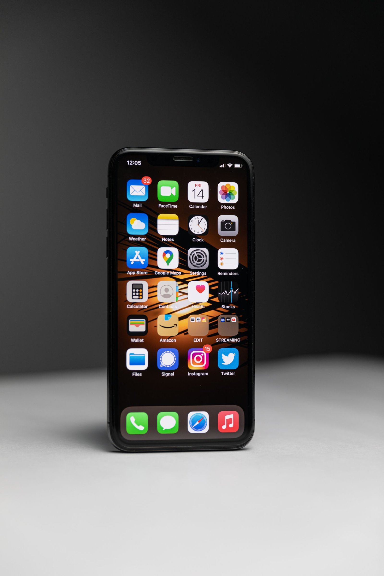 Close-up of a smartphone with an array of app icons against dark background.